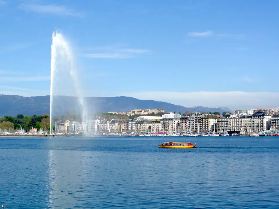 a large fountain spewing water into the air over a body of water