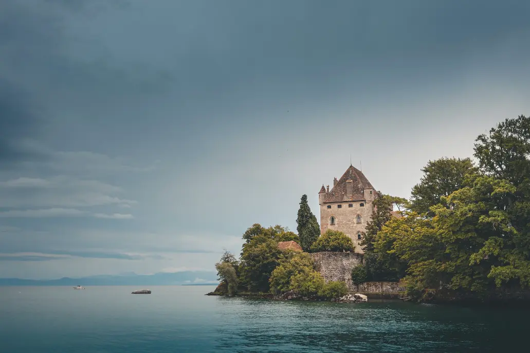 brown concrete building near body of water during daytime