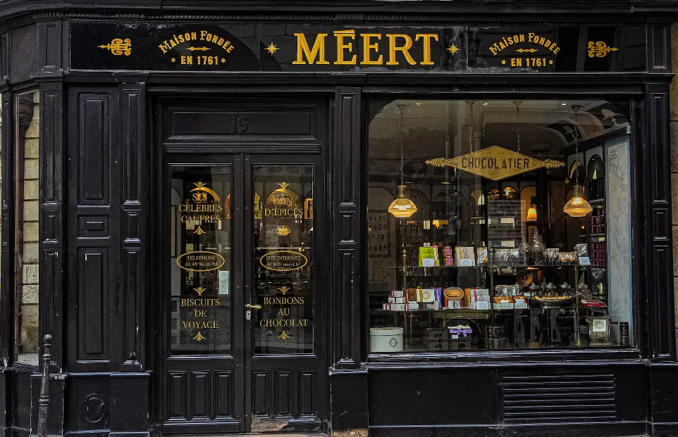 a black store front with gold lettering on it