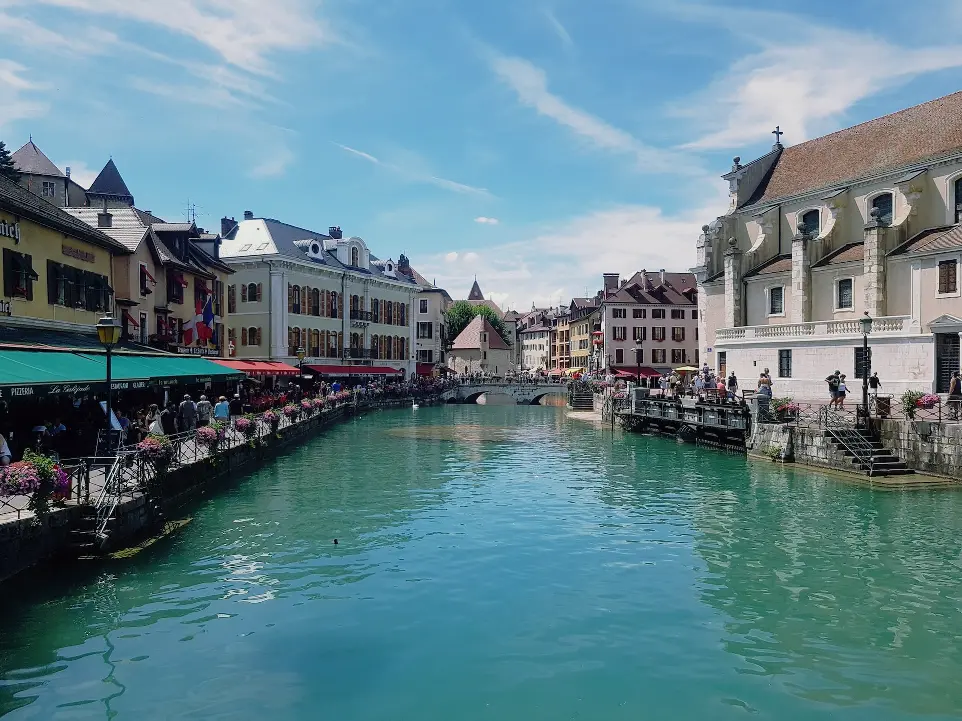 a river running through a city next to tall buildings